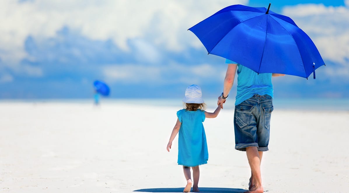 Father and daughter walkin on the beach under a blue umbrella. Metaphor for Basal cell carcinoma, skin cancer and skin lesions